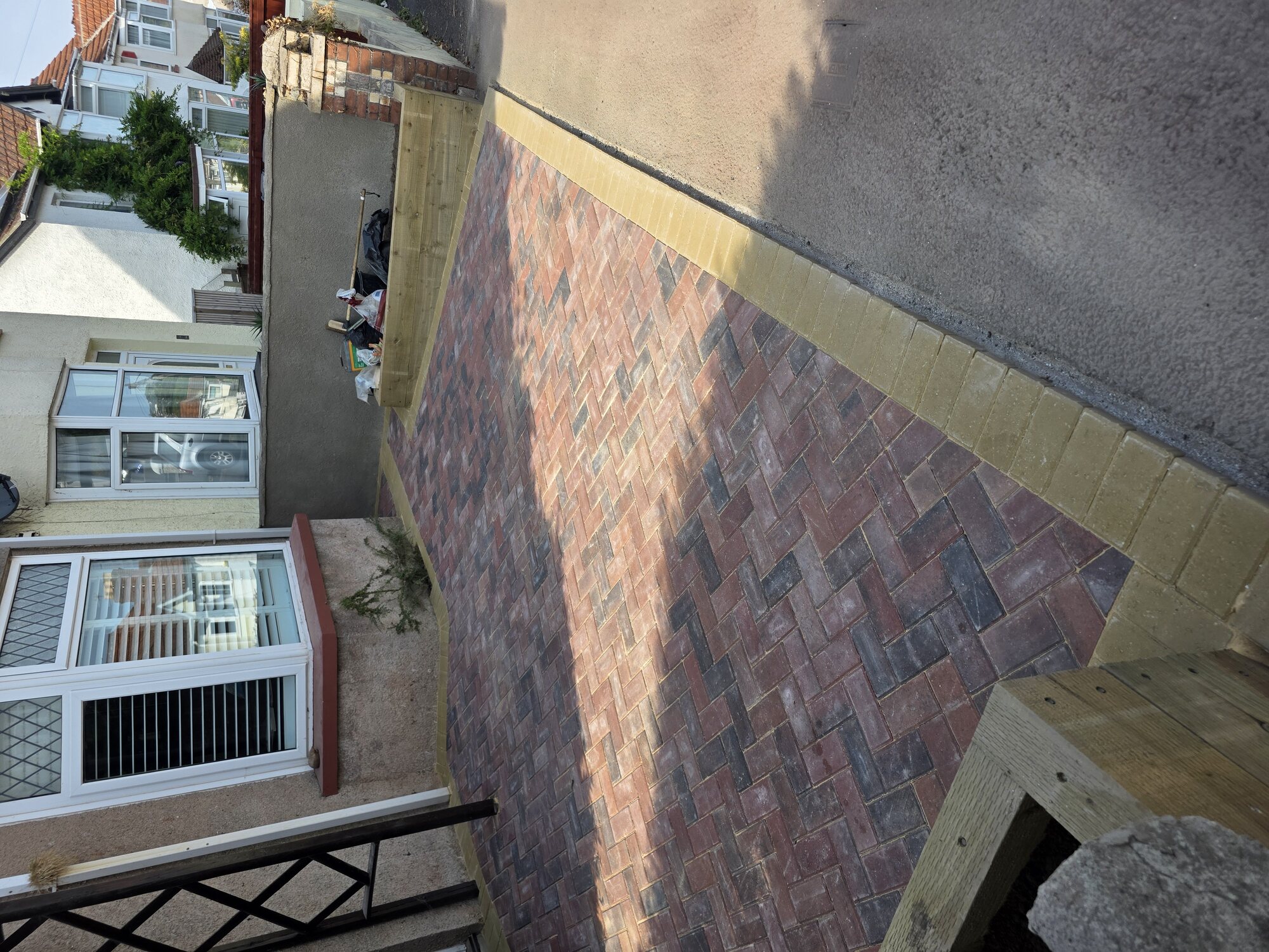 Red and charcoal block-paved front driveway with contrasting border