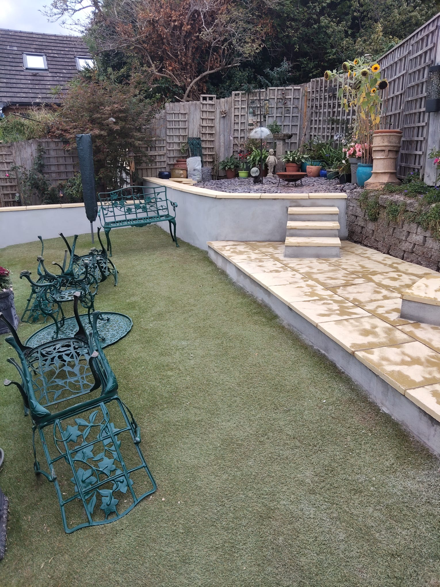Tiered landscaped garden with paved steps and seating areas